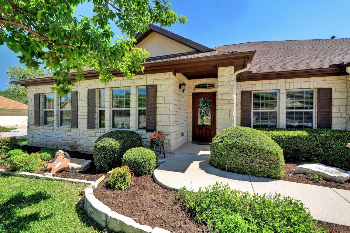 a front view of a house with garden