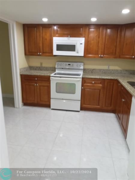 a kitchen with a stove top oven and sink