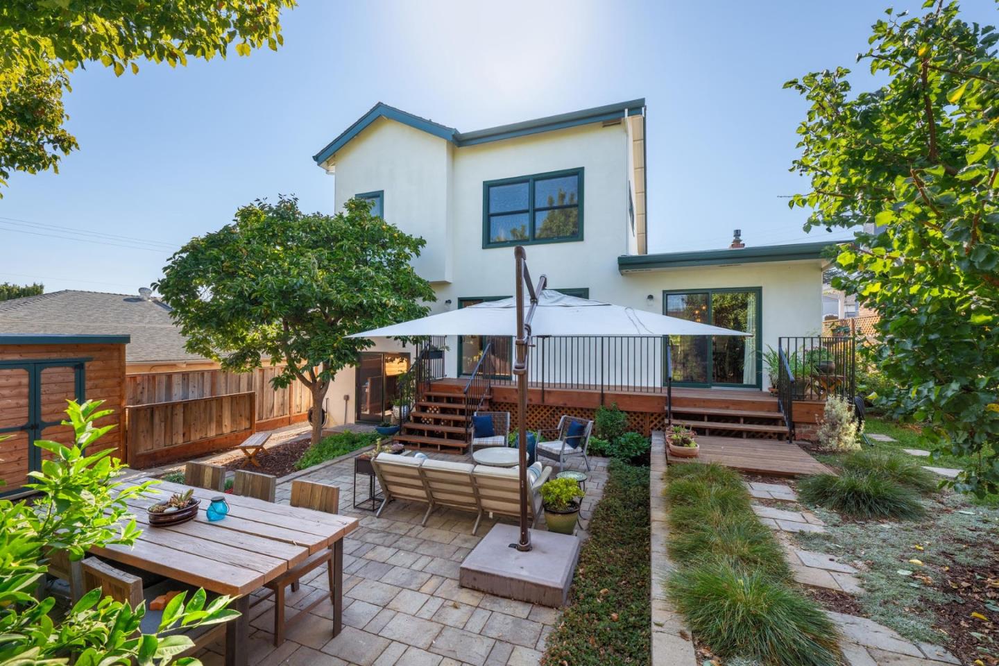 a backyard of a house with barbeque oven table and chairs