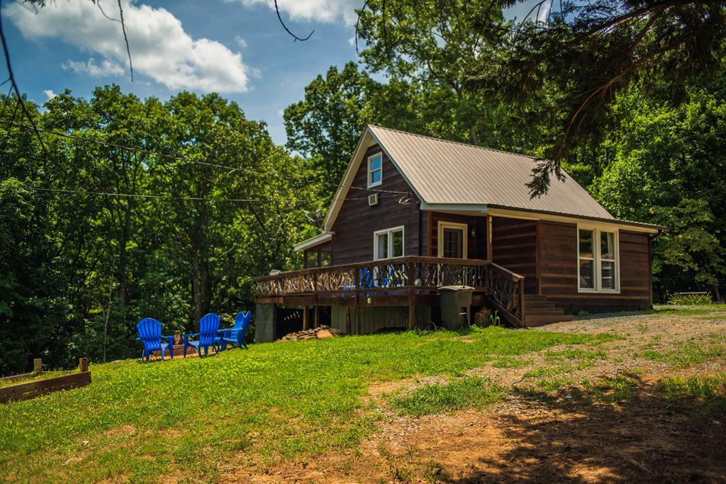 a view of a house with a yard and sitting area