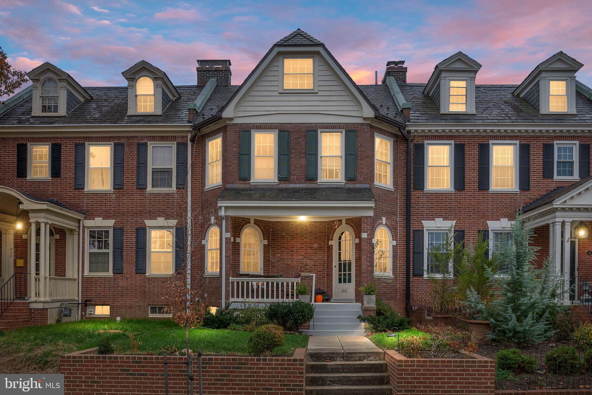 a front view of a residential apartment building with a yard