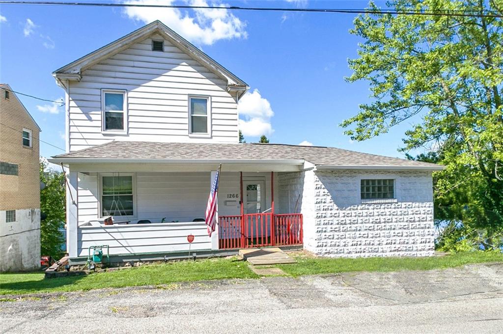 a view of a house with a yard and garage