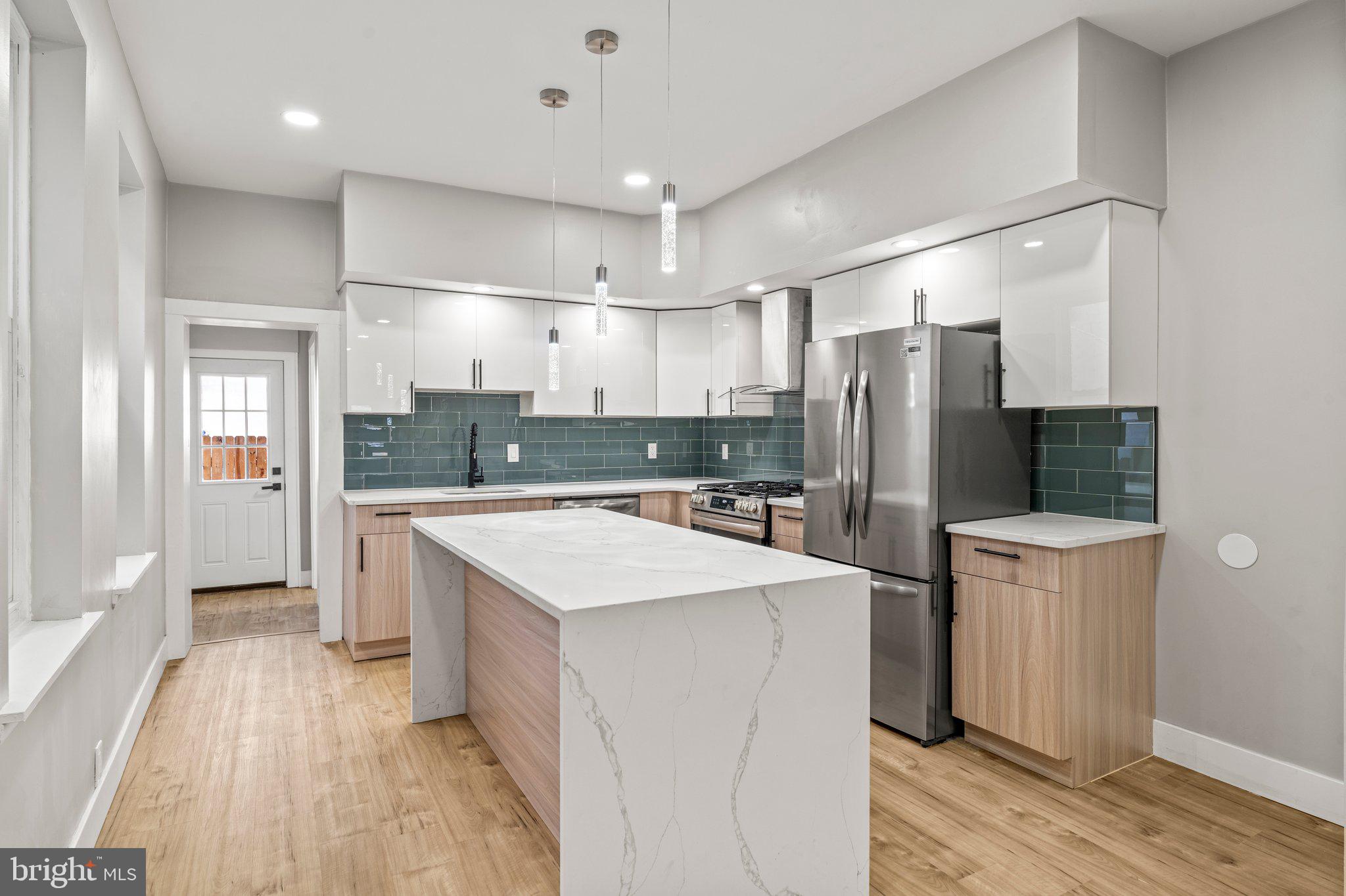 a kitchen with refrigerator and cabinets