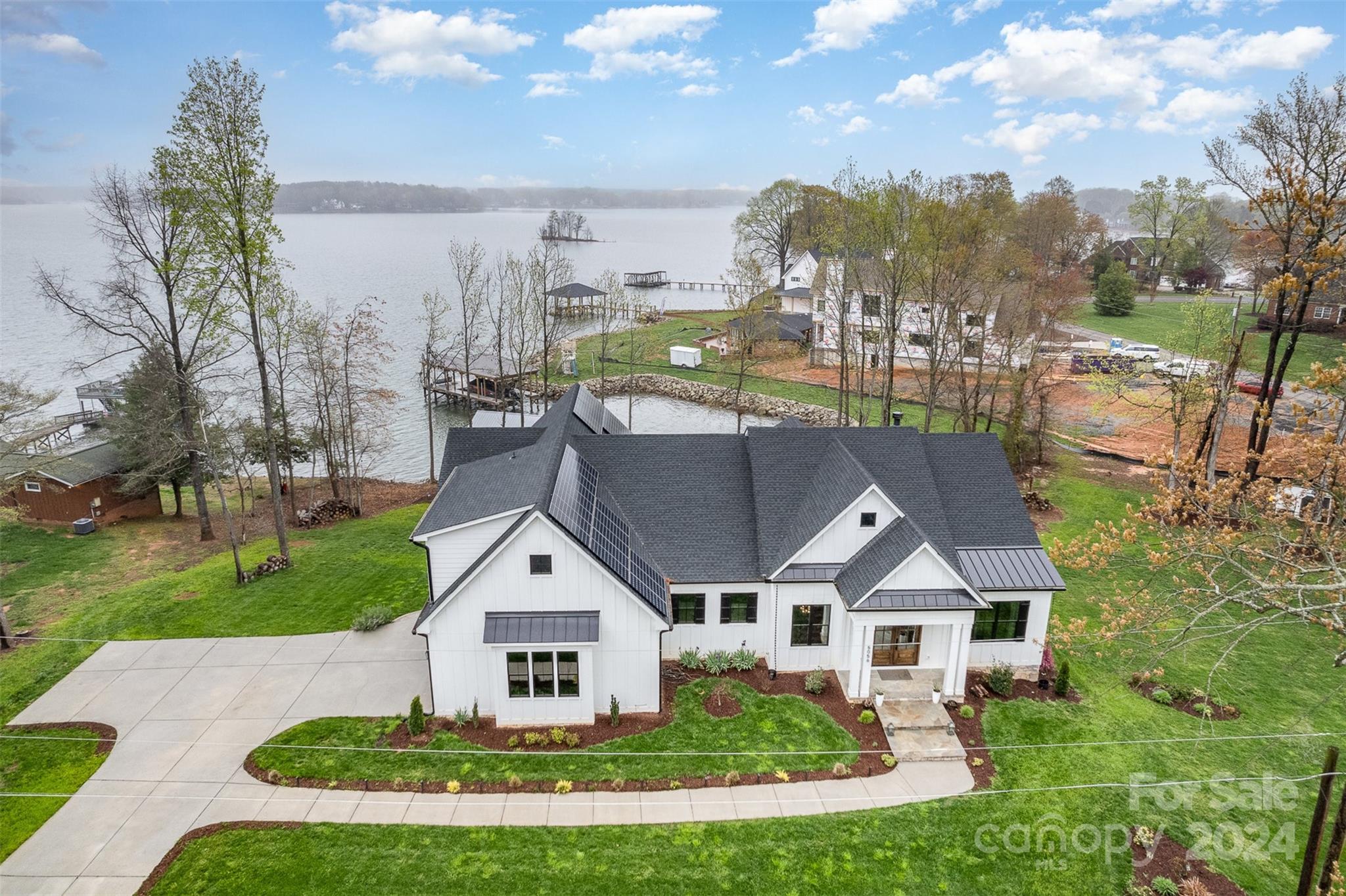 a aerial view of a house with a big yard and large trees