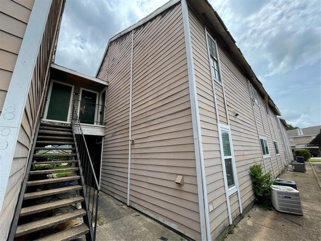 a view of a house with backyard and deck