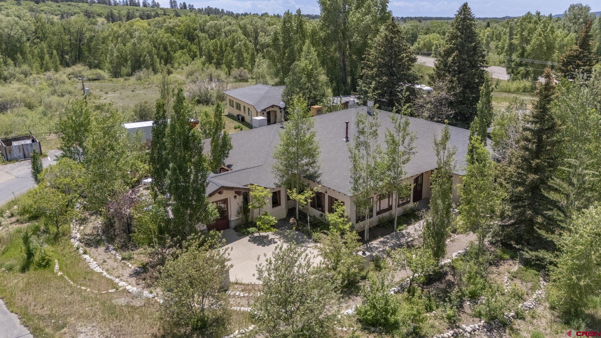 an aerial view of a house with a yard