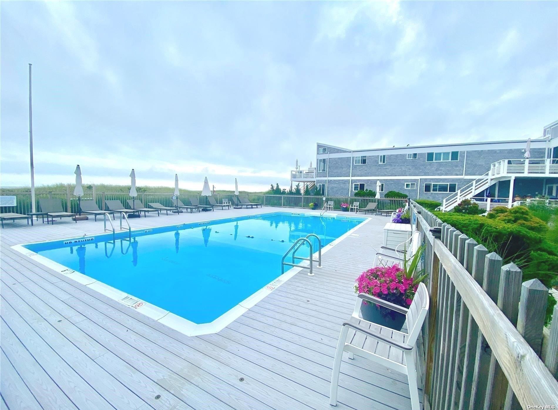 a view of a swimming pool with lounge chairs