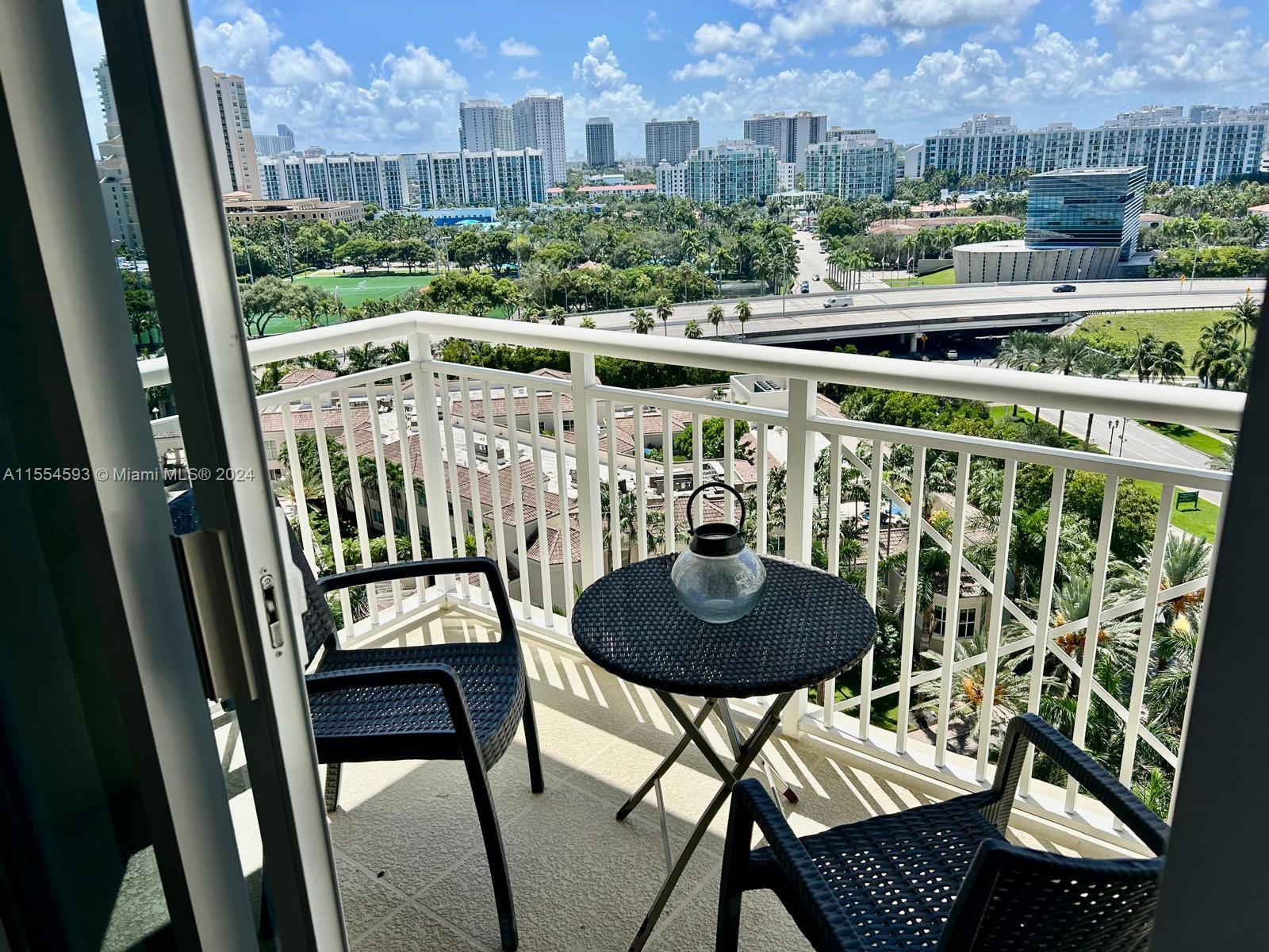 a view of a chairs and table in the balcony