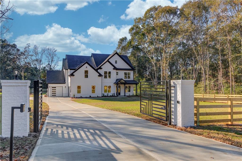 a view of a house with wooden fence