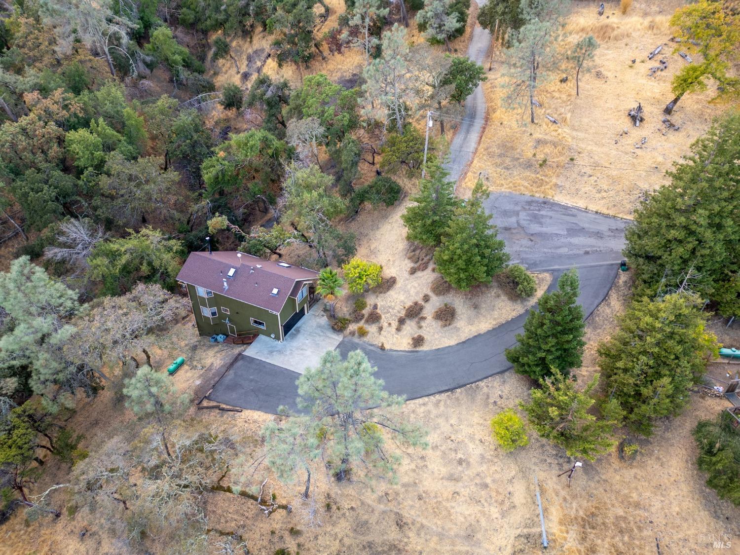 an aerial view of a house with a yard