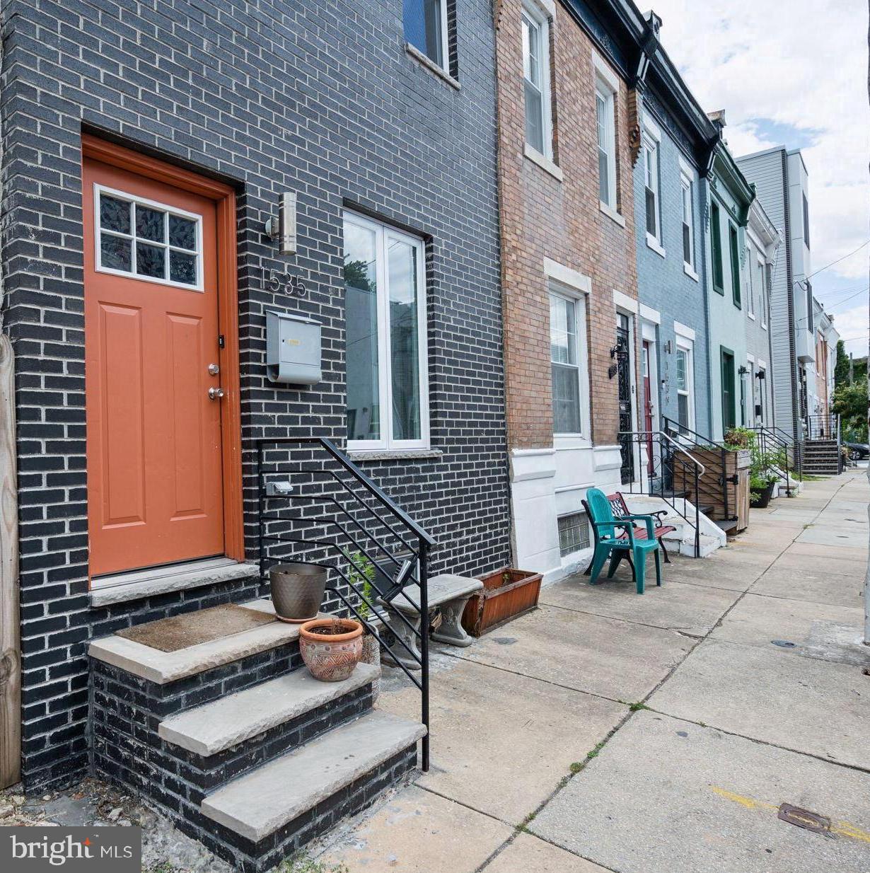 a backyard of a house with barbeque oven table and chairs