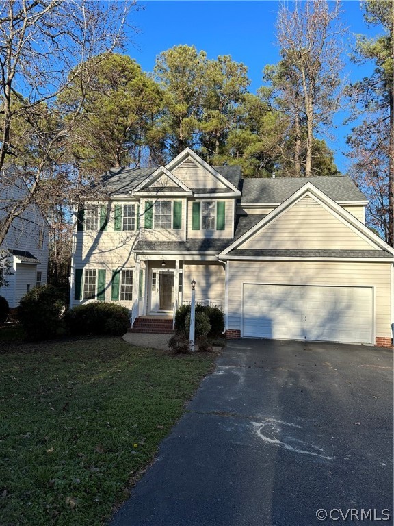 a view of a big house with a big yard and large trees