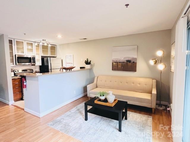 a living room with furniture and kitchen view