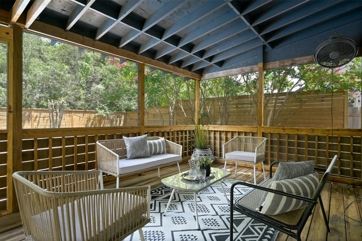 a roof deck with couches and wooden floor