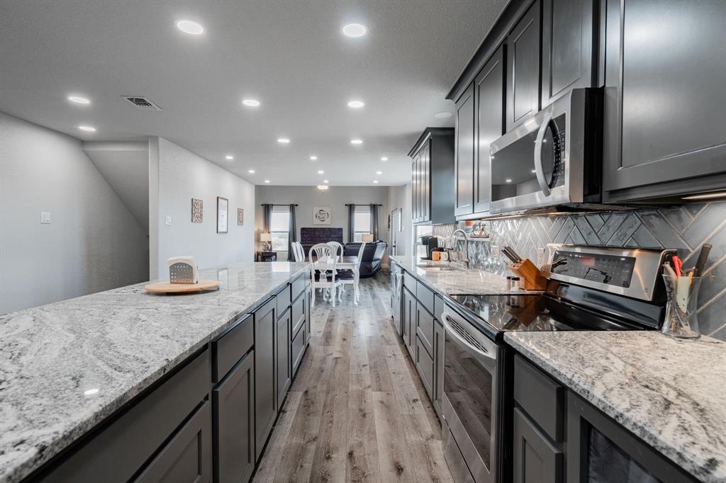 a kitchen with counter top space cabinets and stainless steel appliances