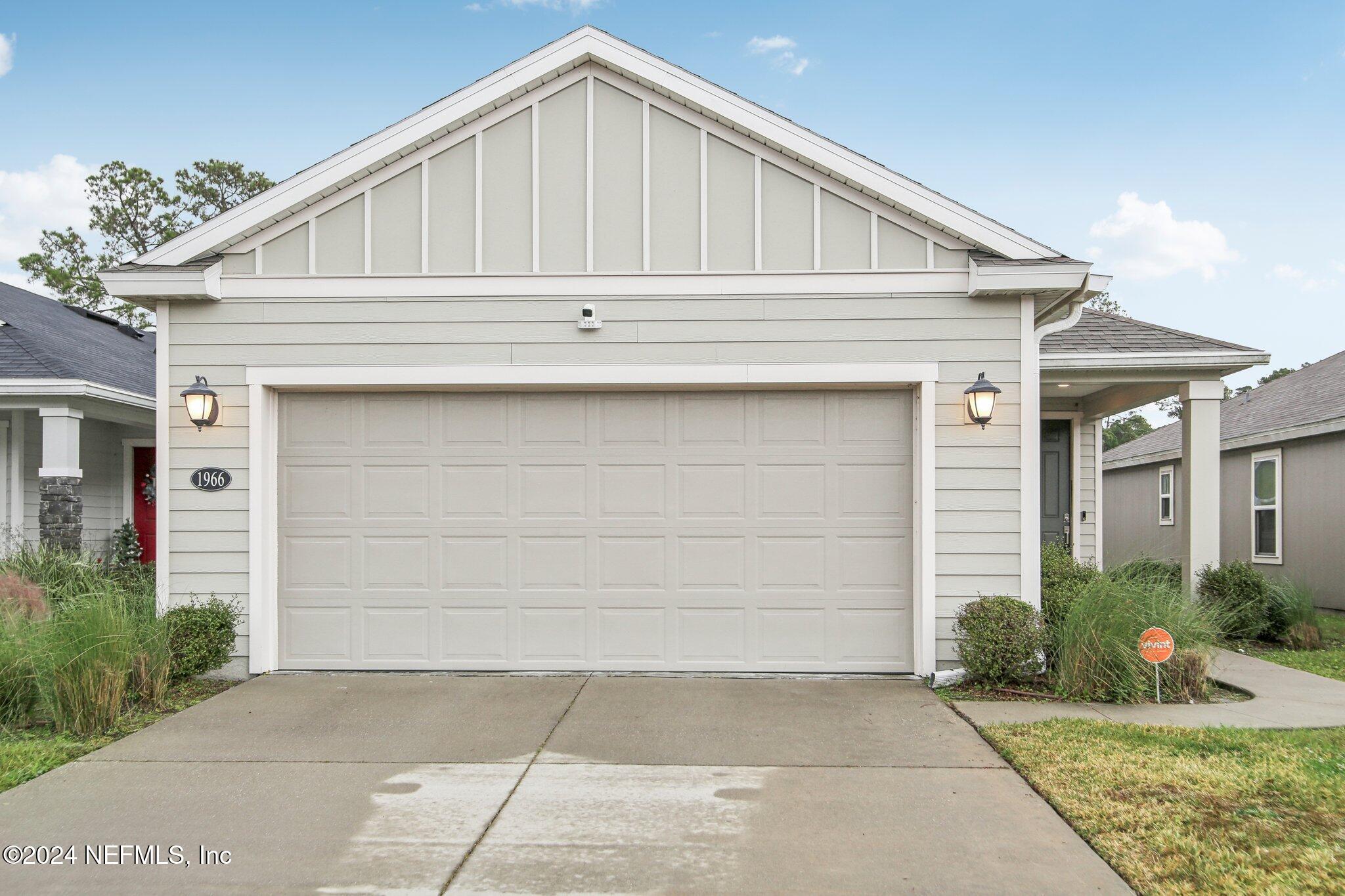 a front view of a house with garage