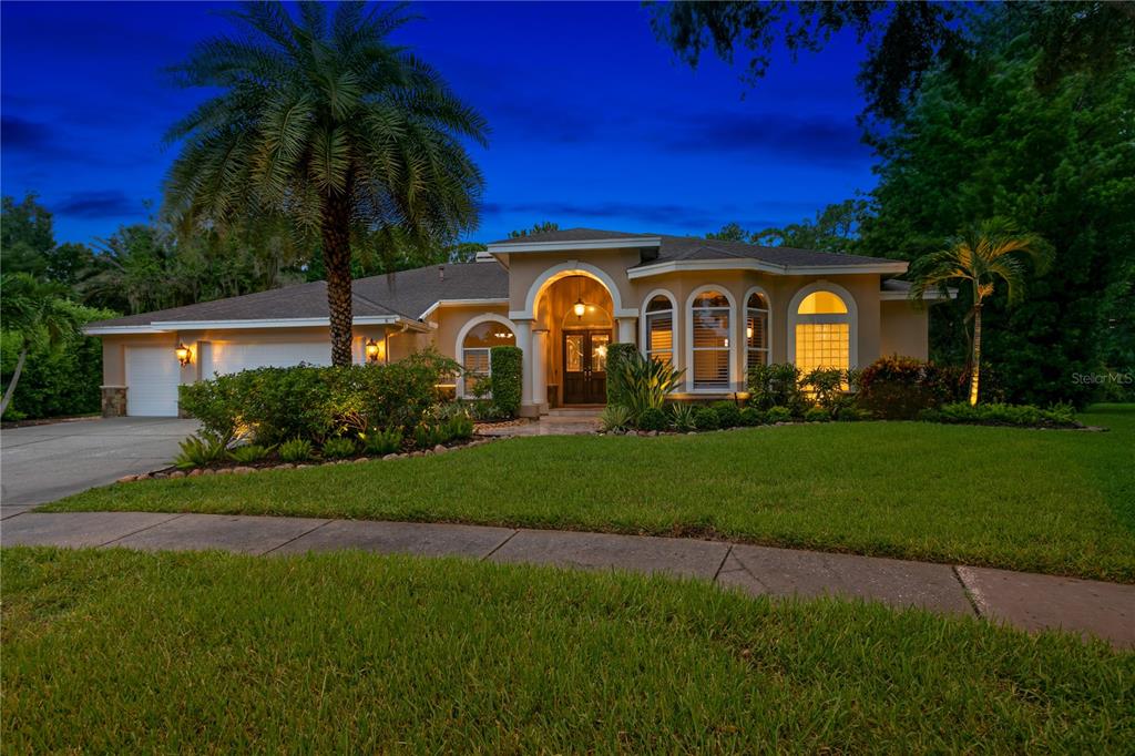 a front view of a house with a garden