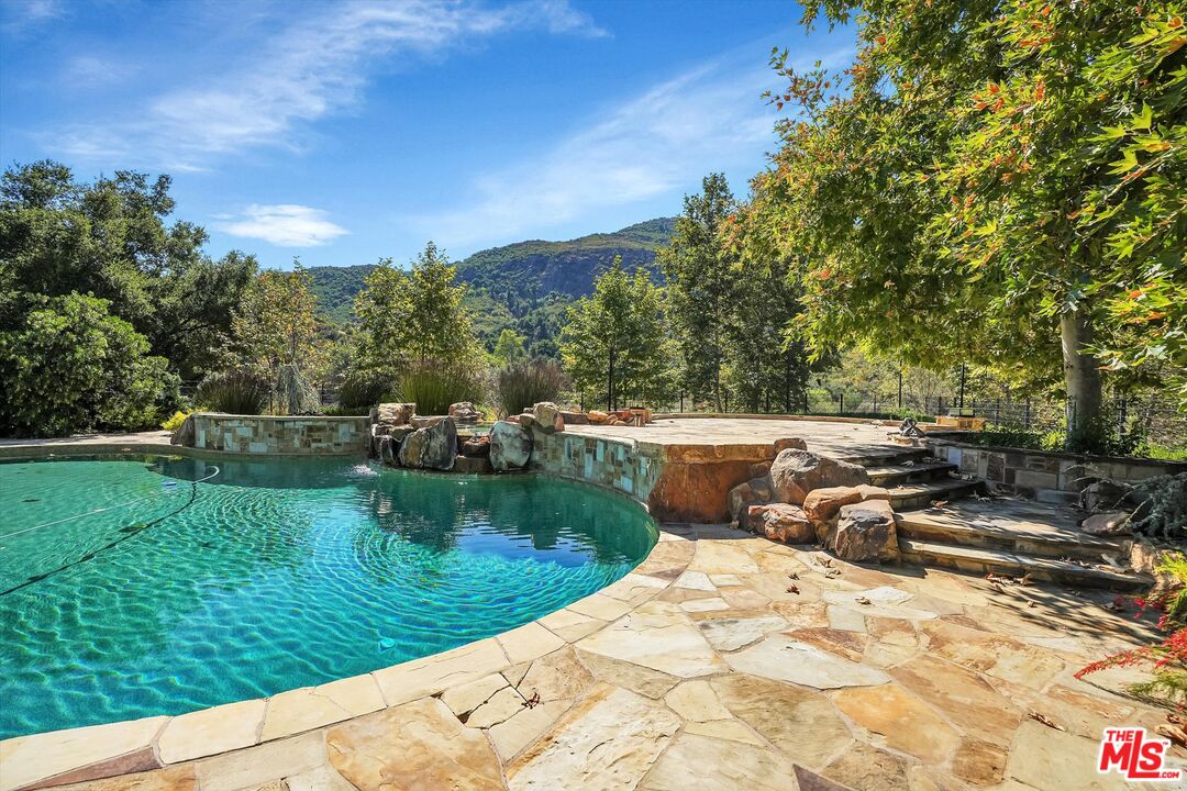 a view of a swimming pool with a yard