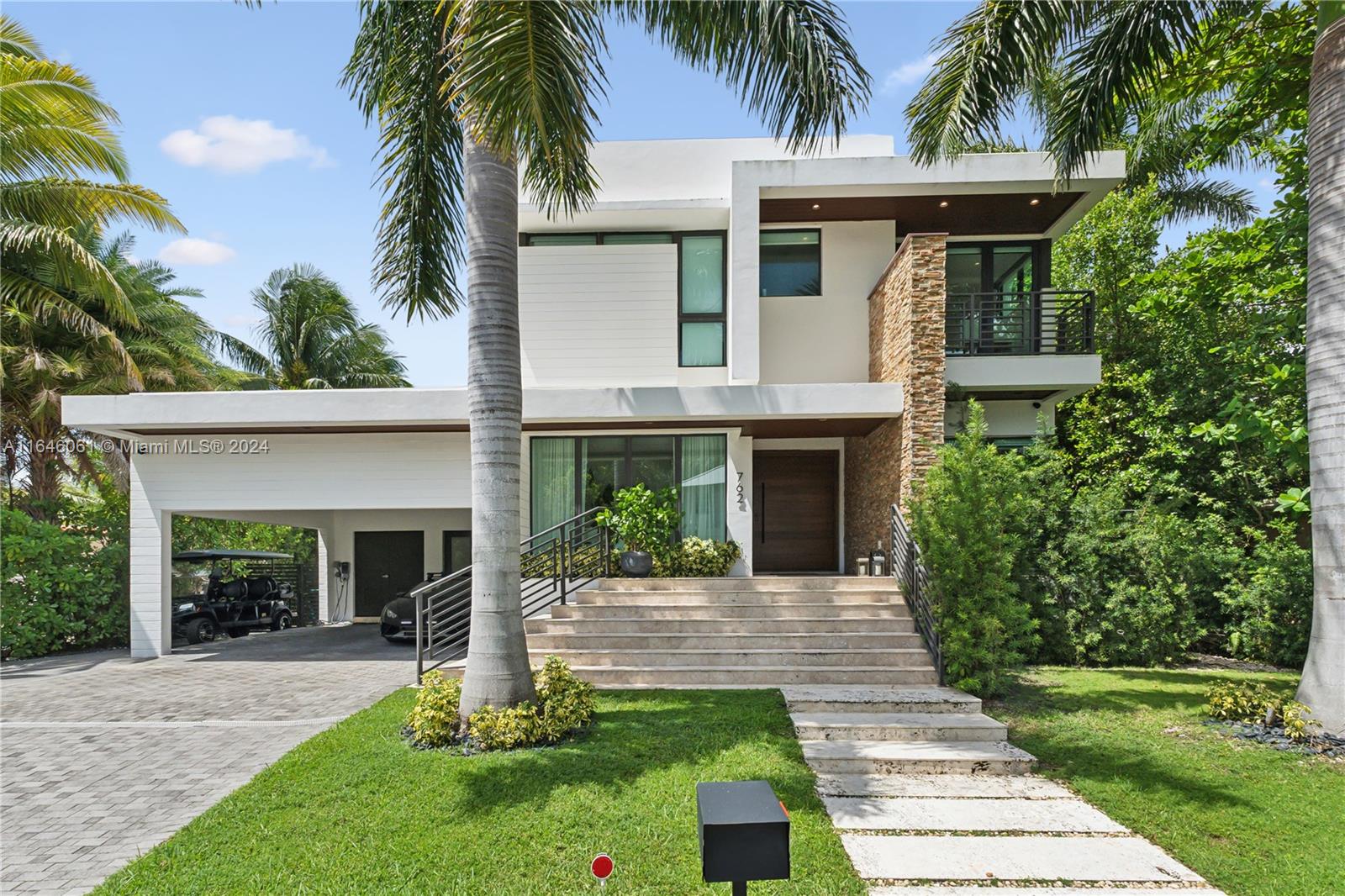 a front view of a house with a garden and plants