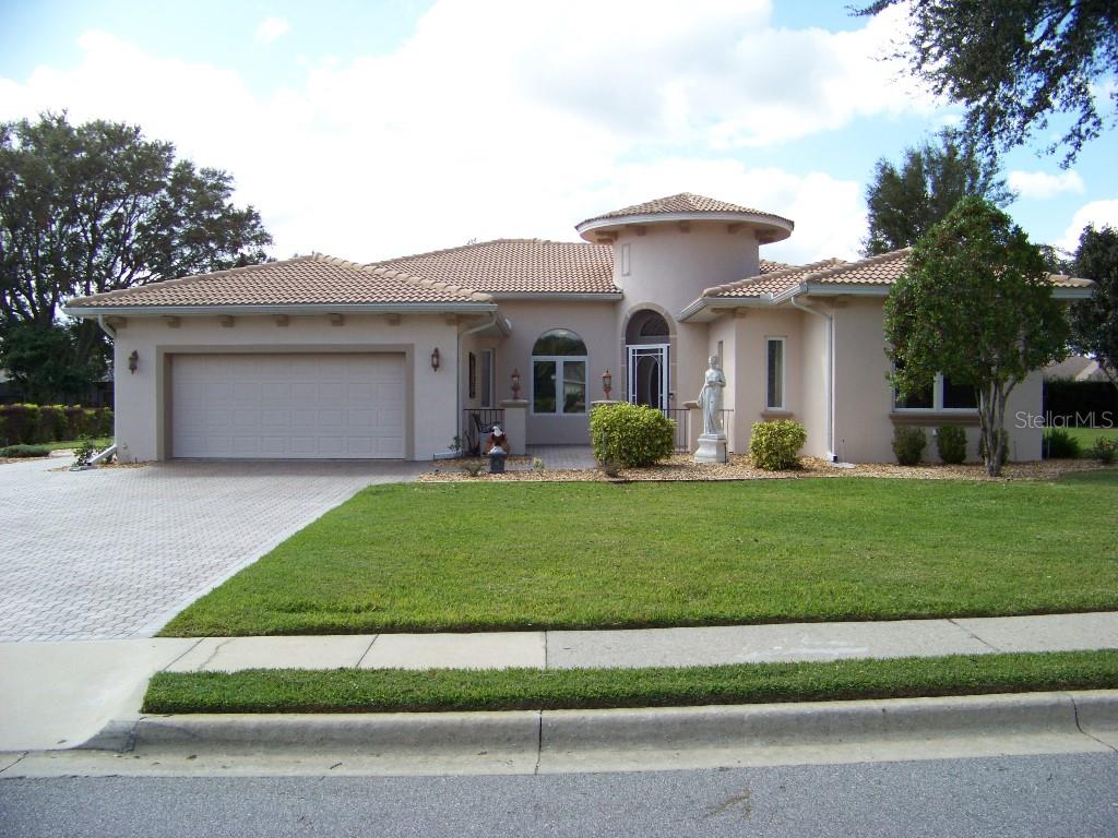 a front view of a house with a garden and plants