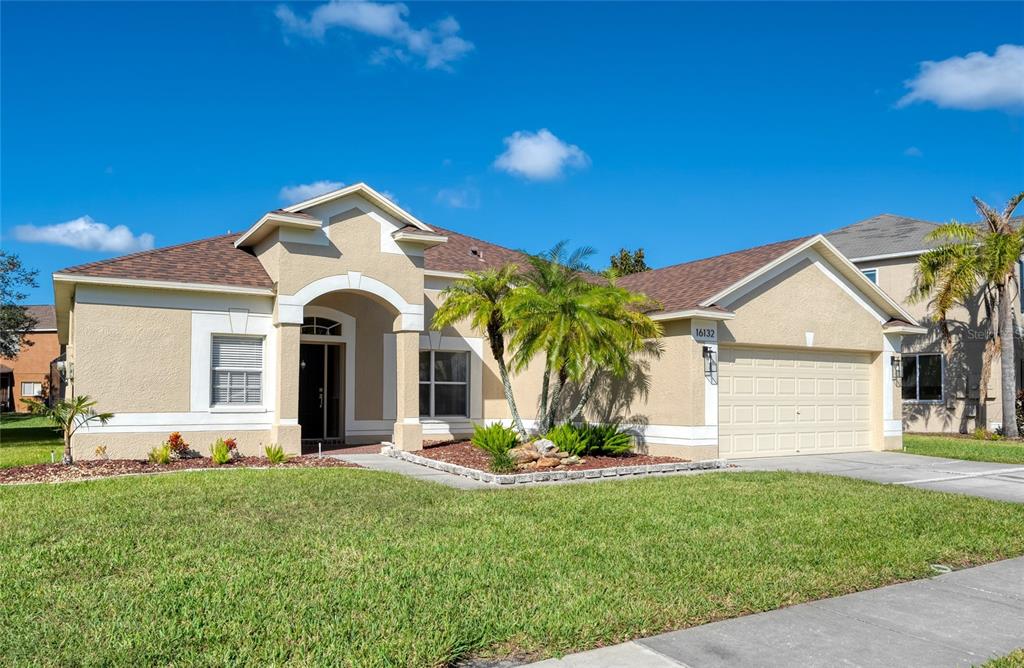 a front view of a house with a yard