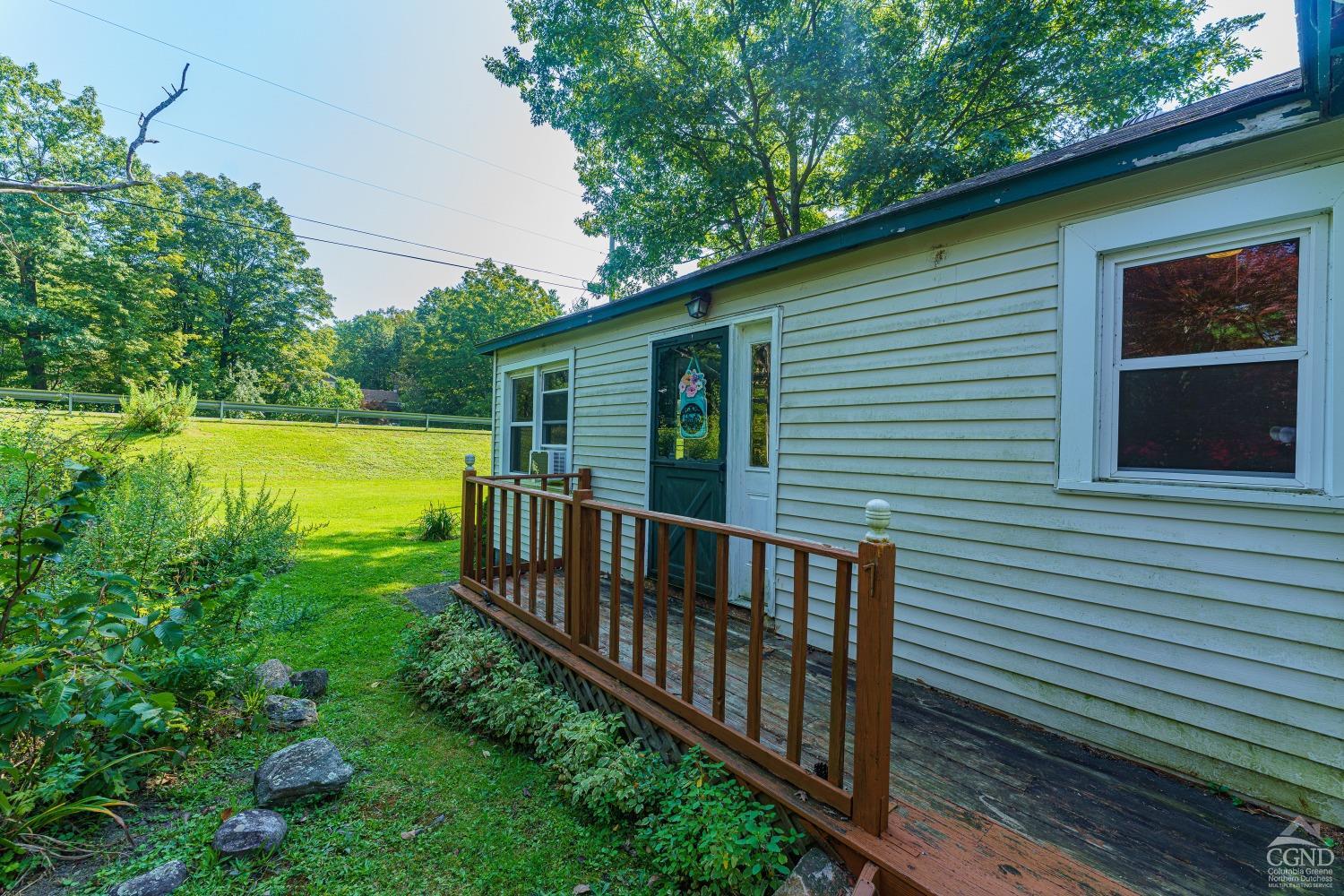 a view of a wooden deck and a yard