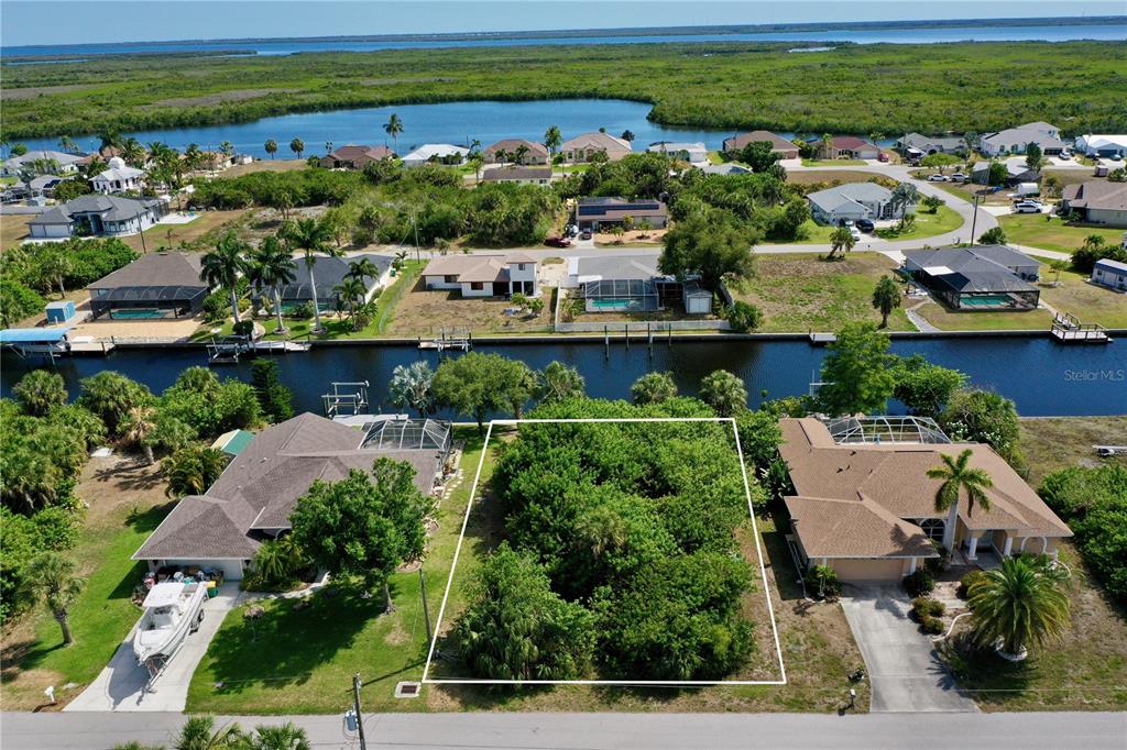 an aerial view of a city with lots of residential buildings ocean and swimming pool