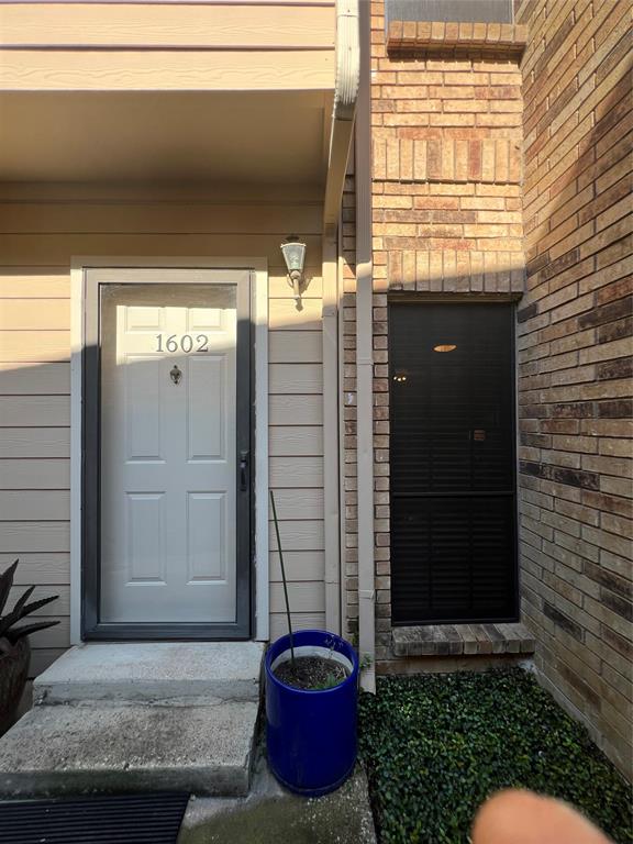 a view of a door of a house with potted plants