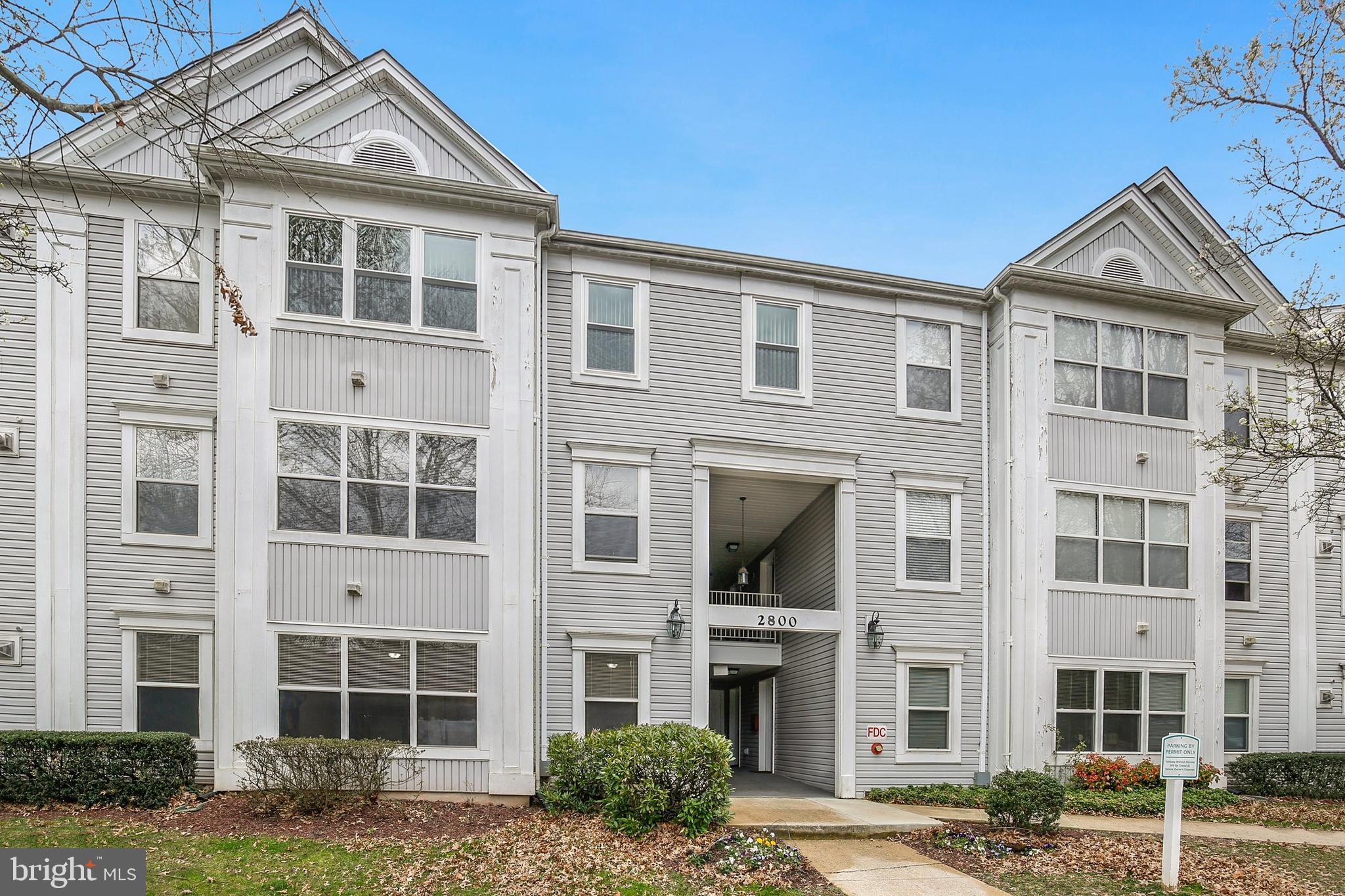 a front view of a residential apartment building with a yard