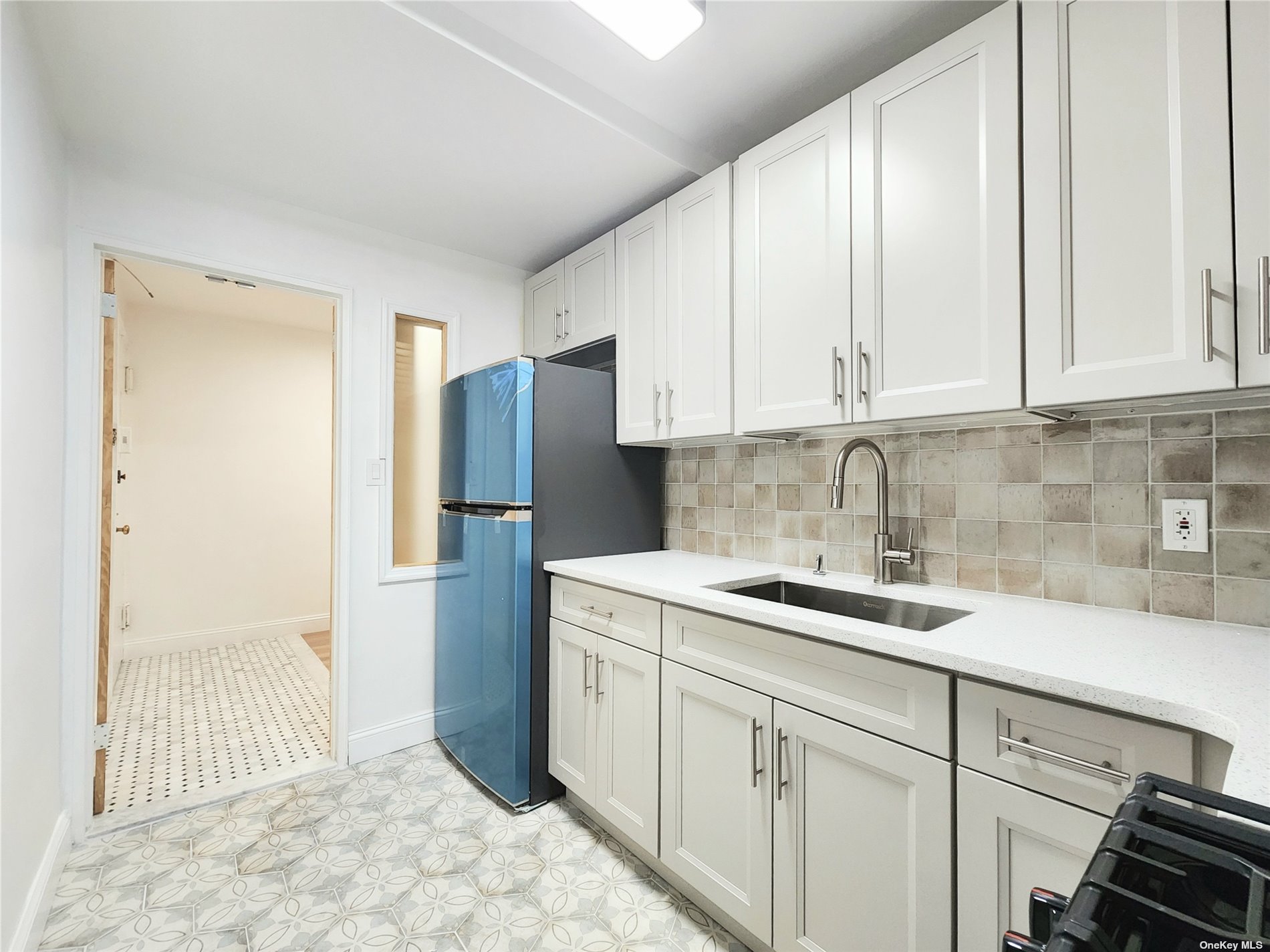 a kitchen with a sink and refrigerator