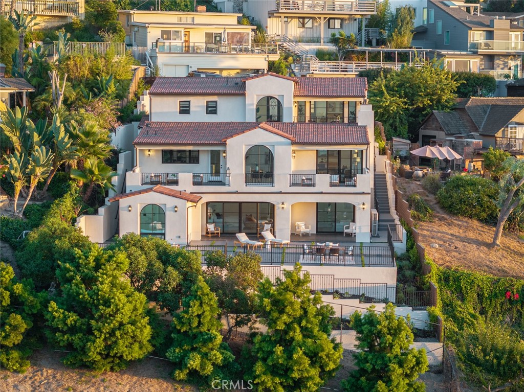 an aerial view of multiple houses with a yard