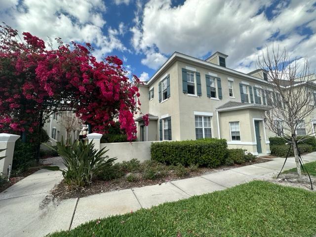 a front view of a house with a garden