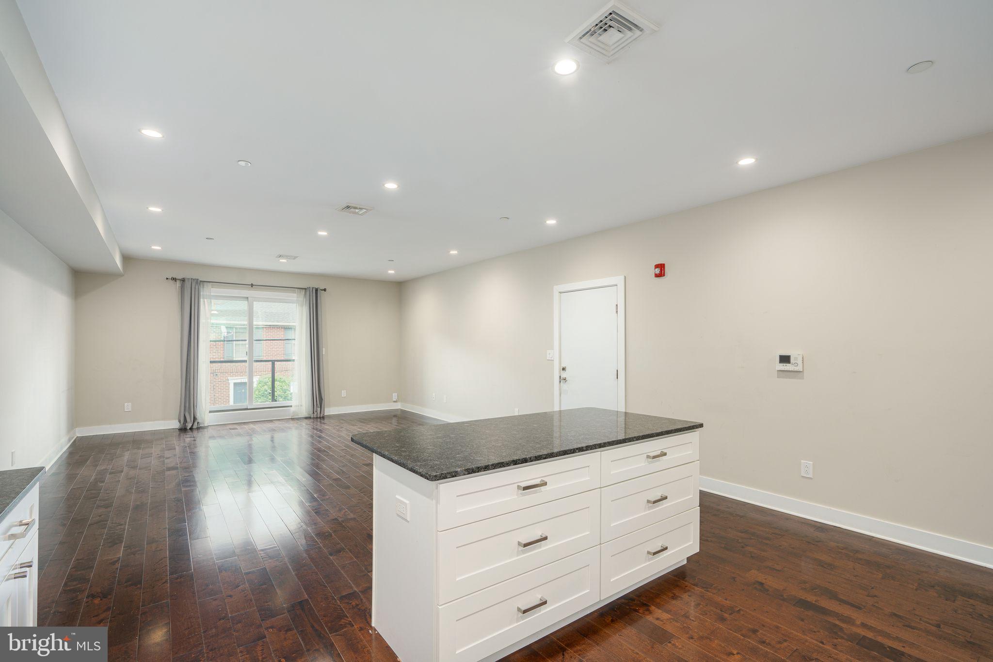 a view of wooden floor and windows in a room