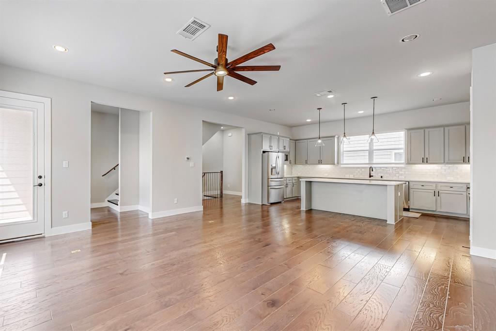 a view of a kitchen with a sink stainless steel appliances and cabinets