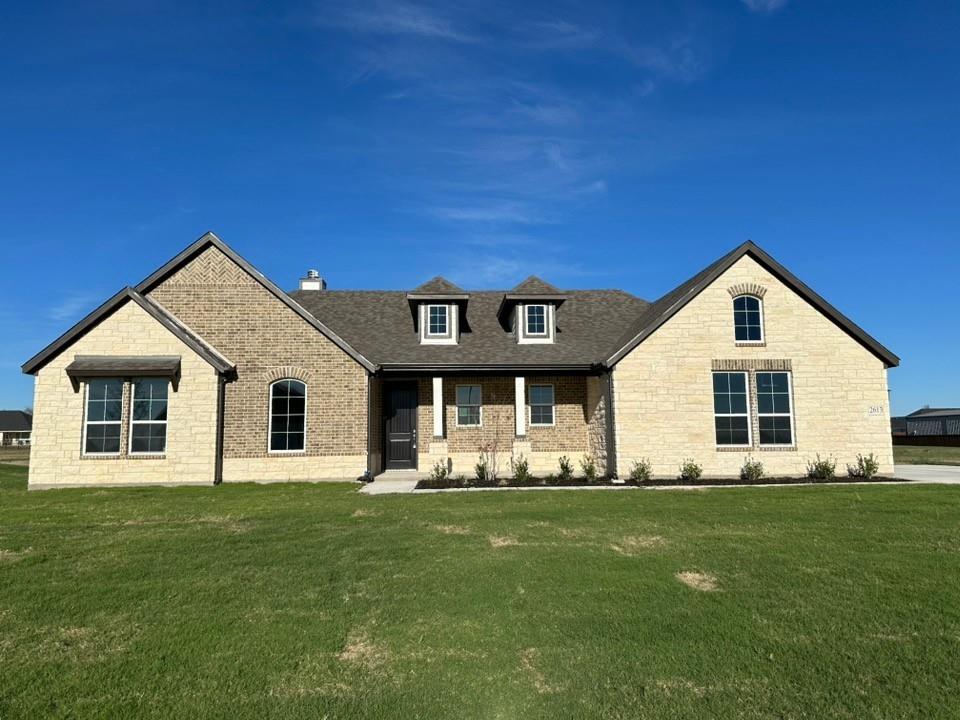 a front view of house with yard and green space