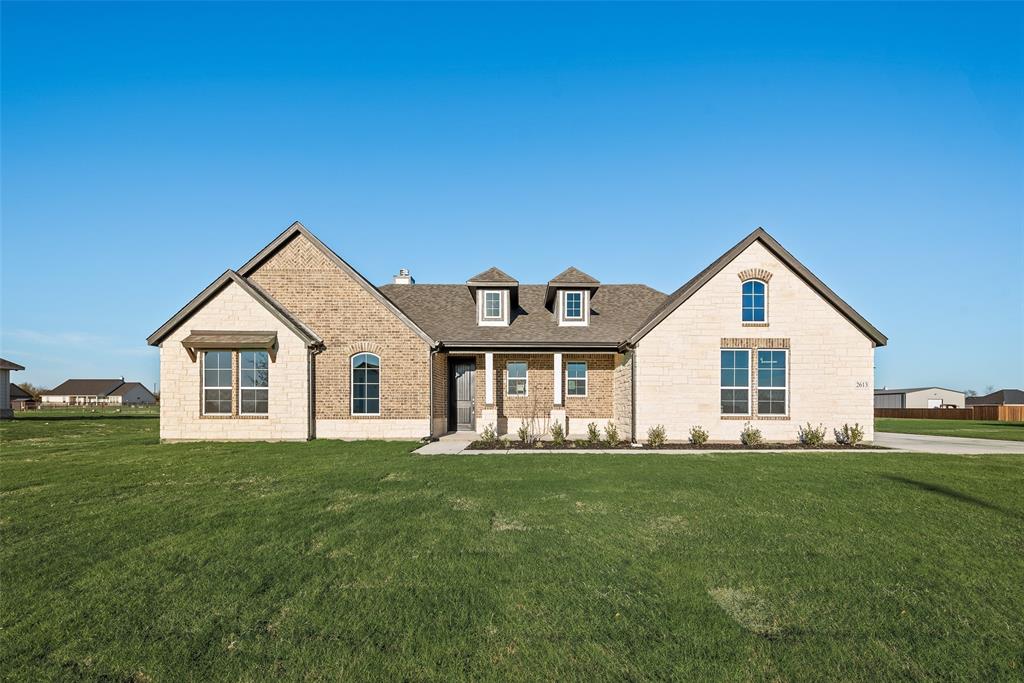 a front view of house with yard and green space