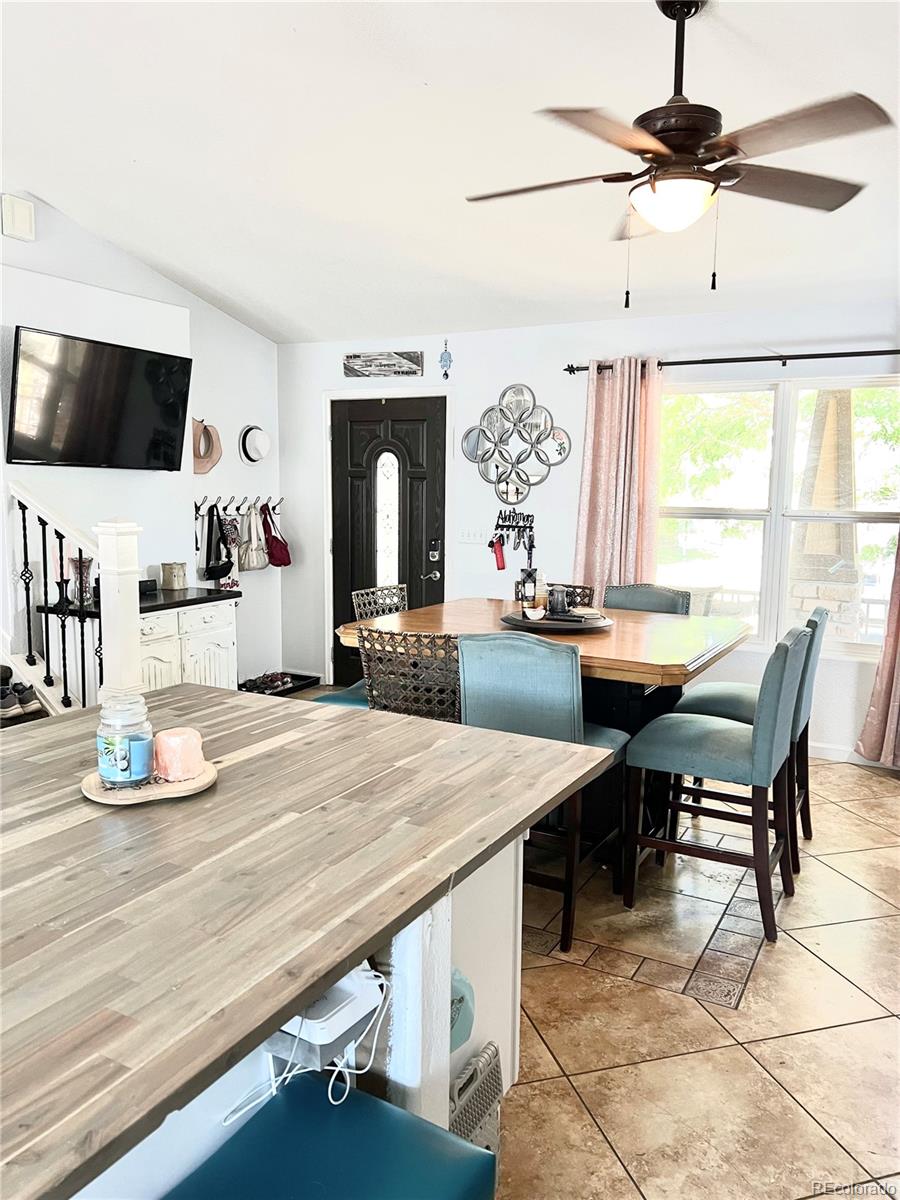 a dining room with kitchen island furniture and a flat screen tv