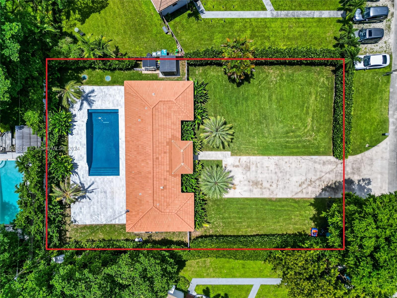 an aerial view of a house with a yard and lake view