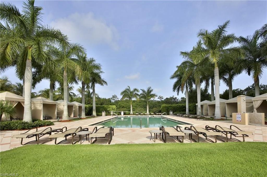 a view of a house with swimming pool and sitting area