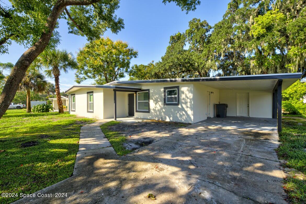 a front view of a house with a yard and porch