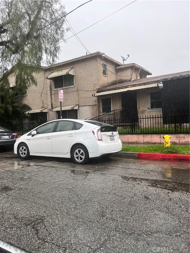 a white car parked in front of house