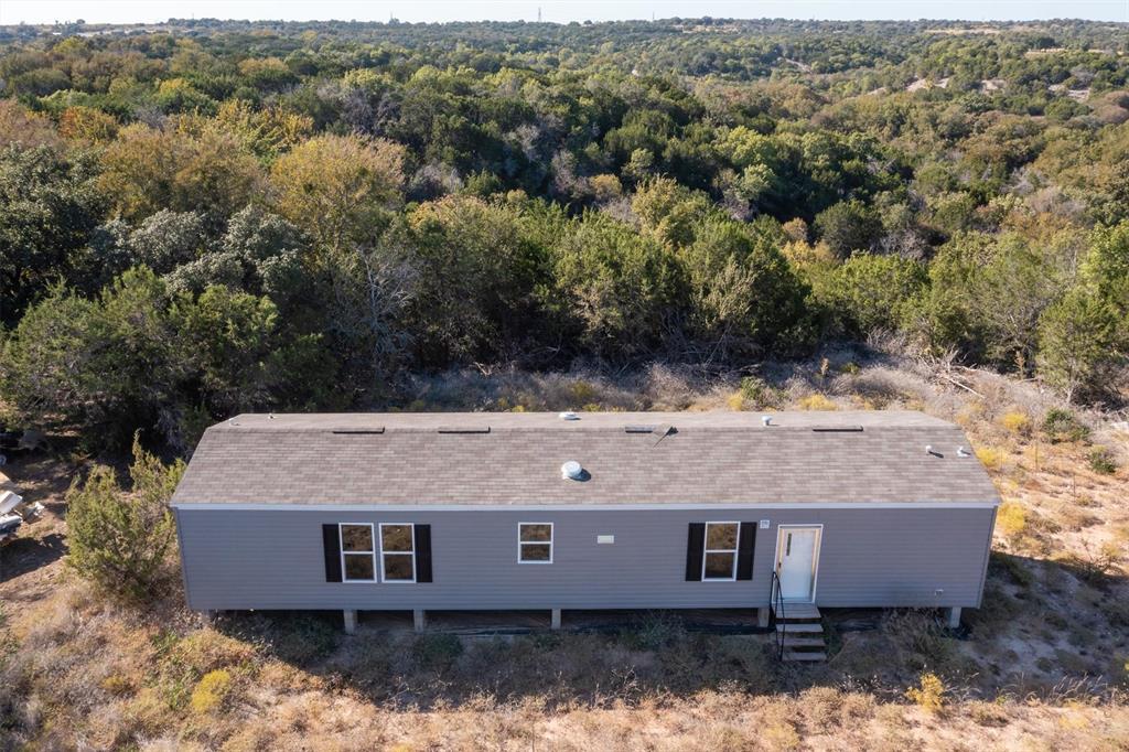 an aerial view of a house with a yard