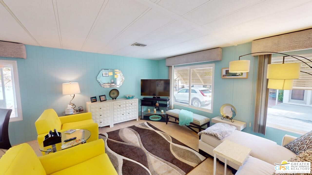 a living room with furniture and a flat screen tv