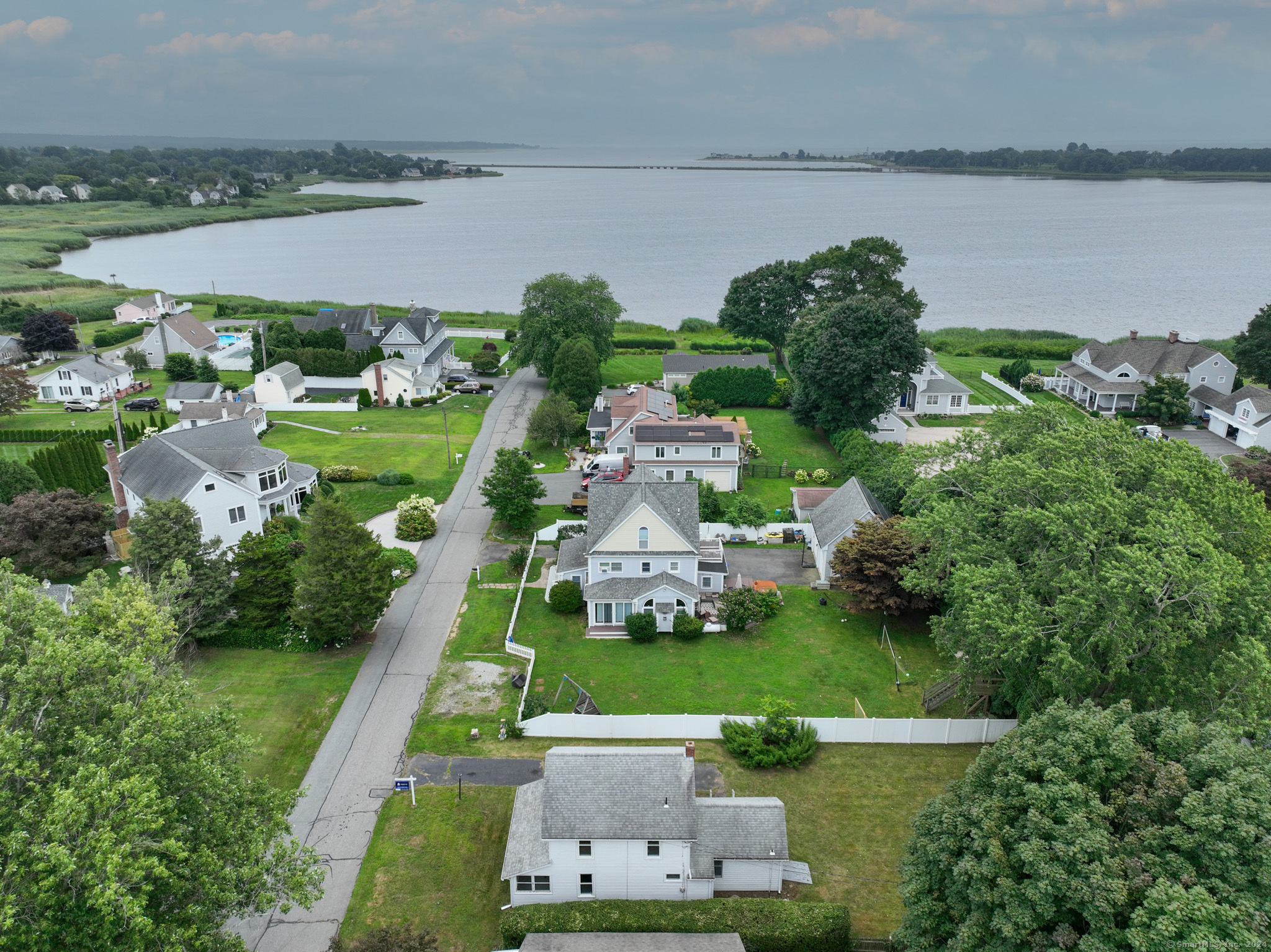 an aerial view of a house with a yard and lake view