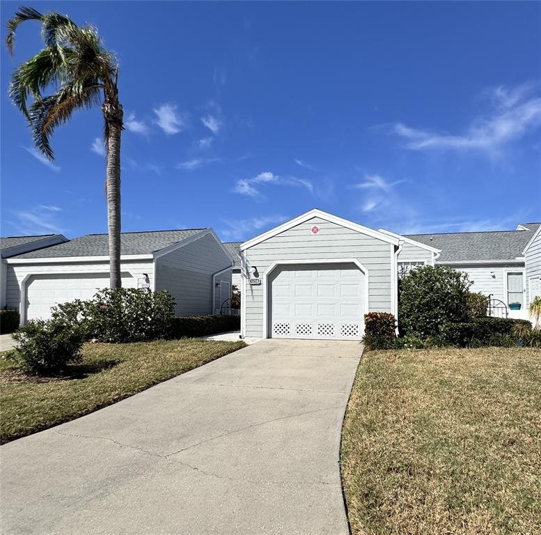 a view of a house with a yard and garage