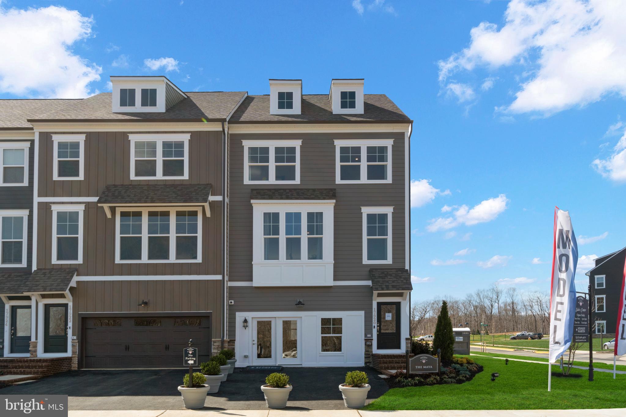 a front view of a residential apartment building with a yard