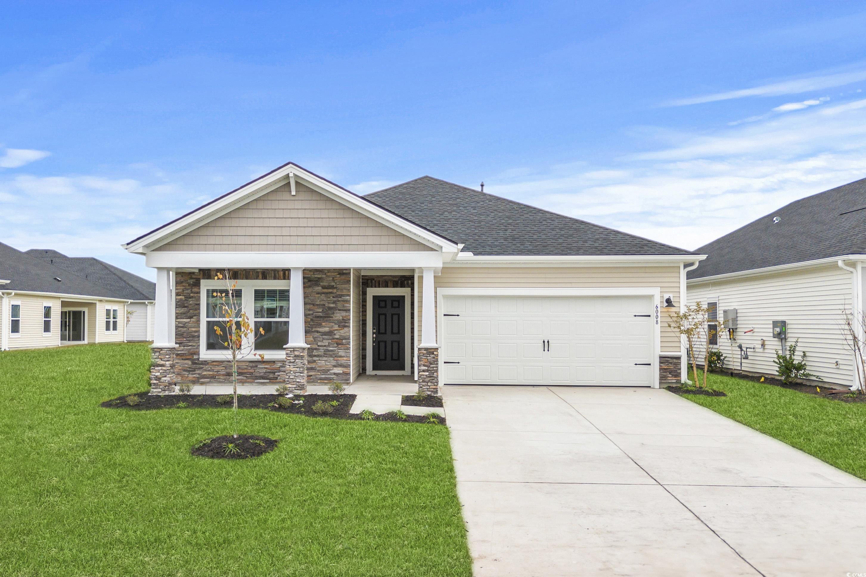 Craftsman-style home with covered porch, a garage,