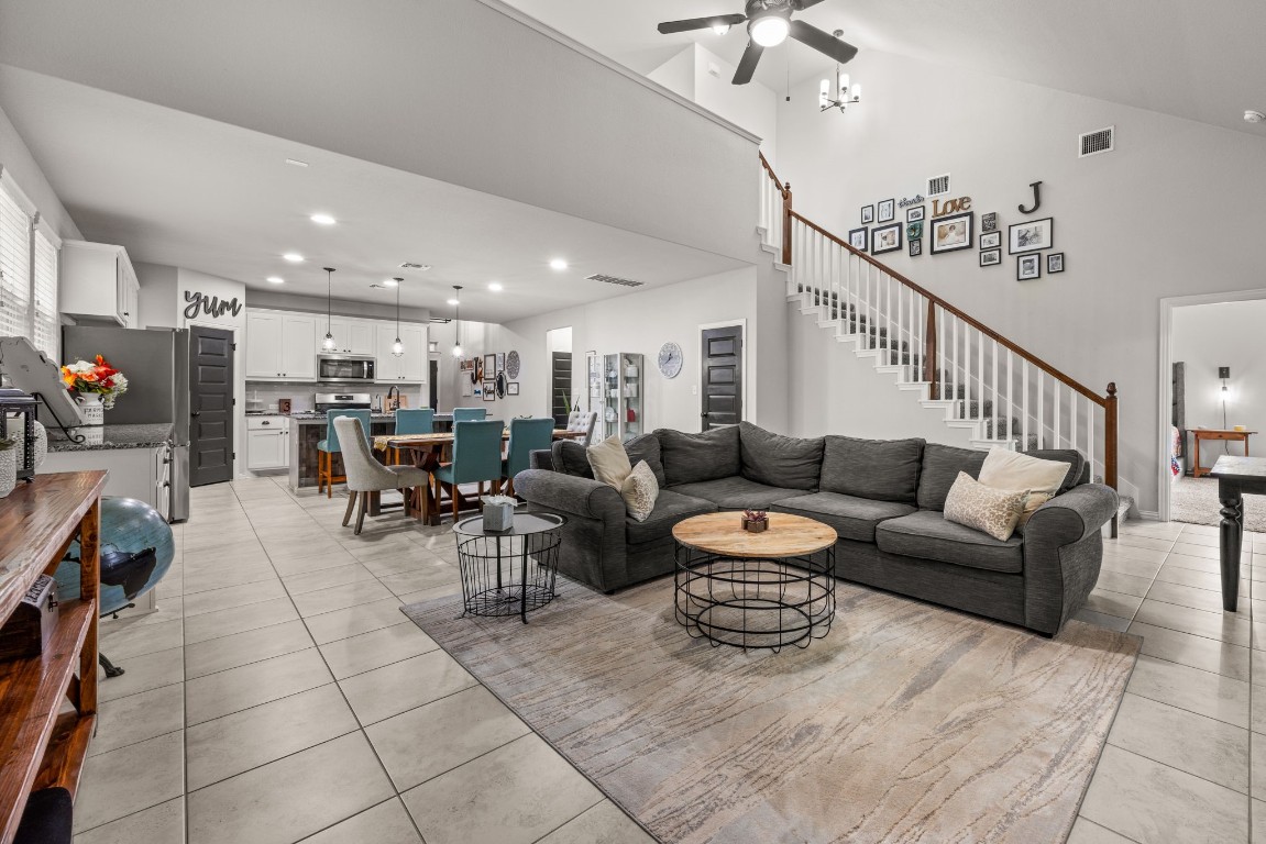 a living room with furniture and a chandelier