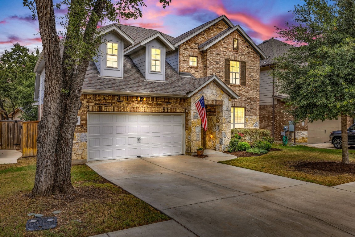 Timeless elegance. The brick and stone facade of this two-story home creates a welcoming and inviting entrance.