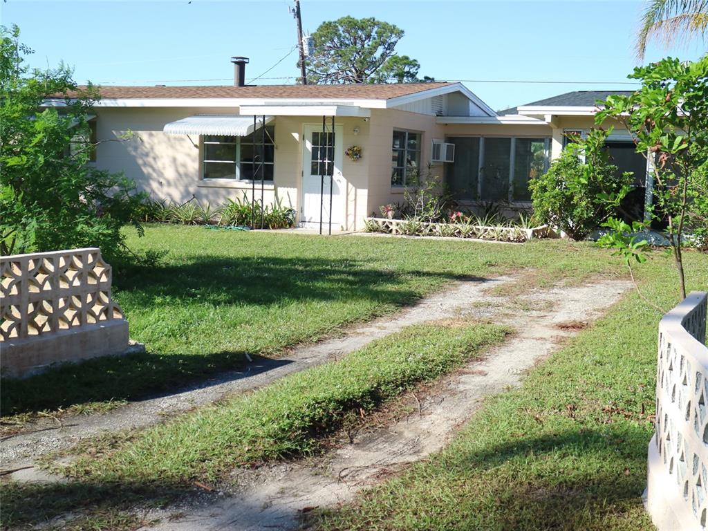 a front view of a house with a yard table and chairs